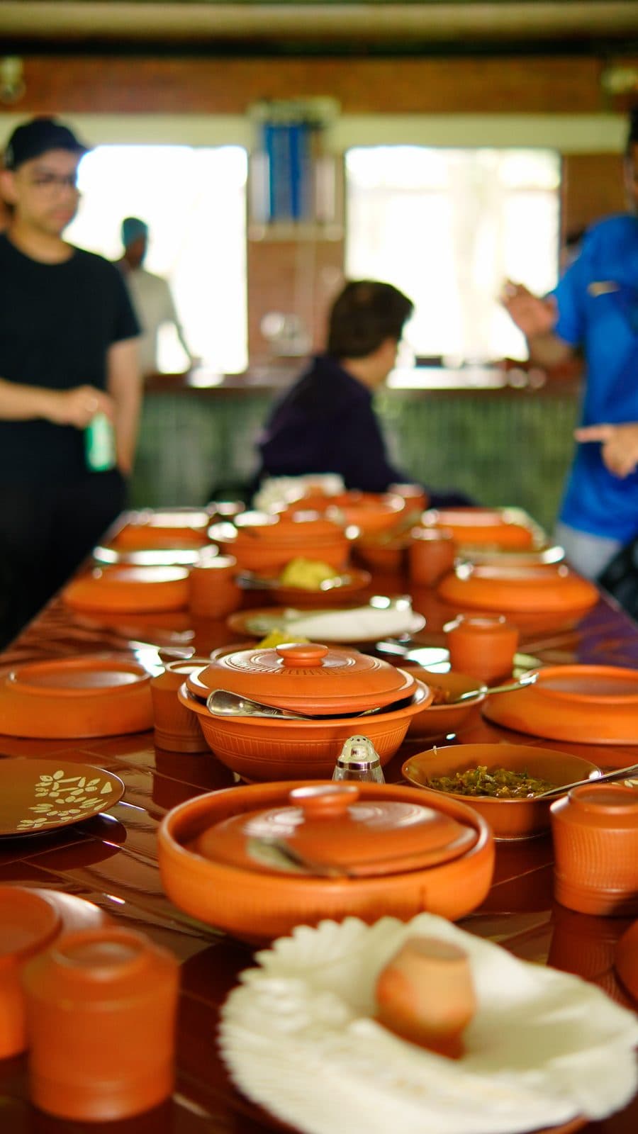A long table set with clay pots