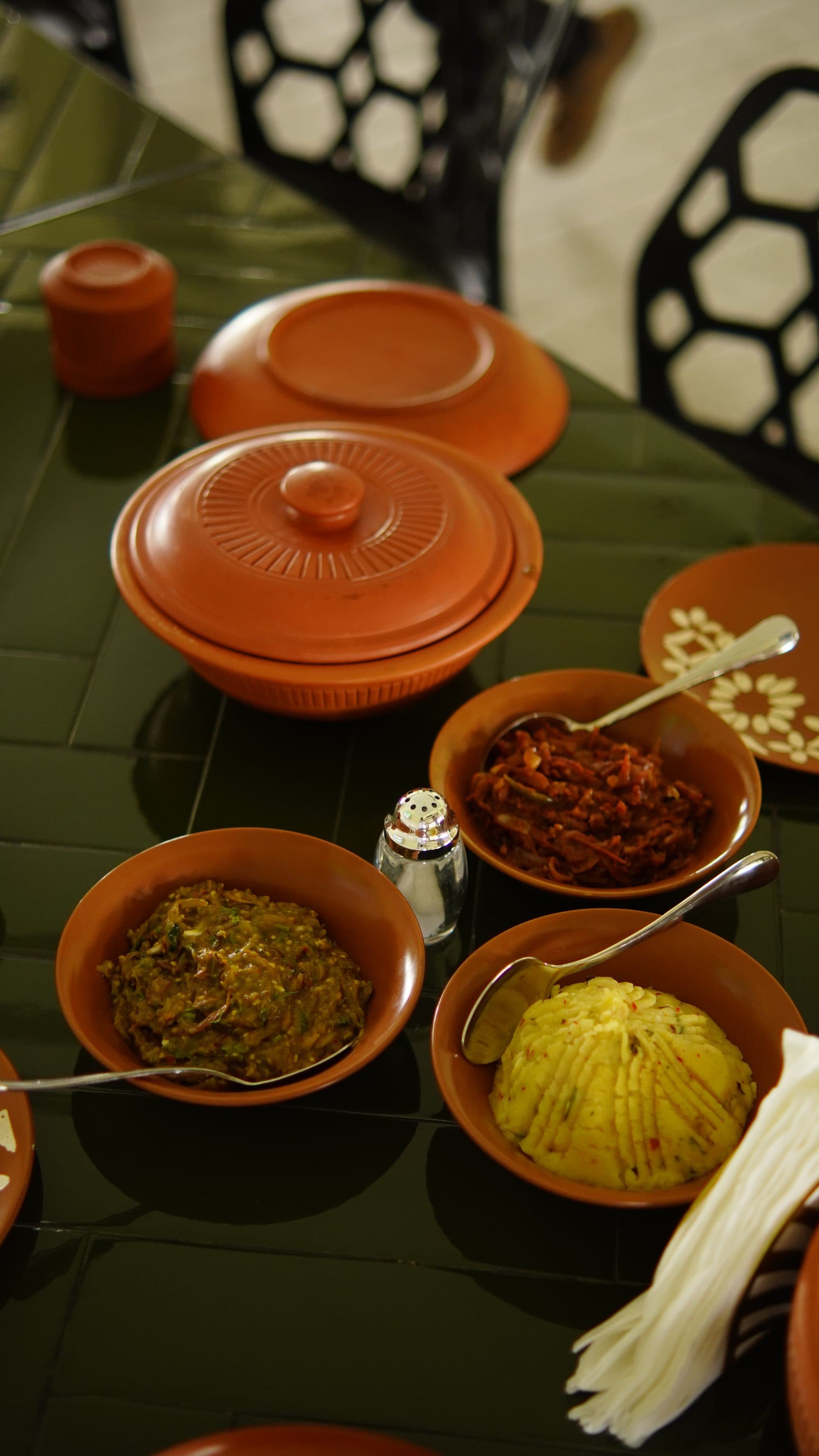 A spread of Bangla dishes served in terracotta