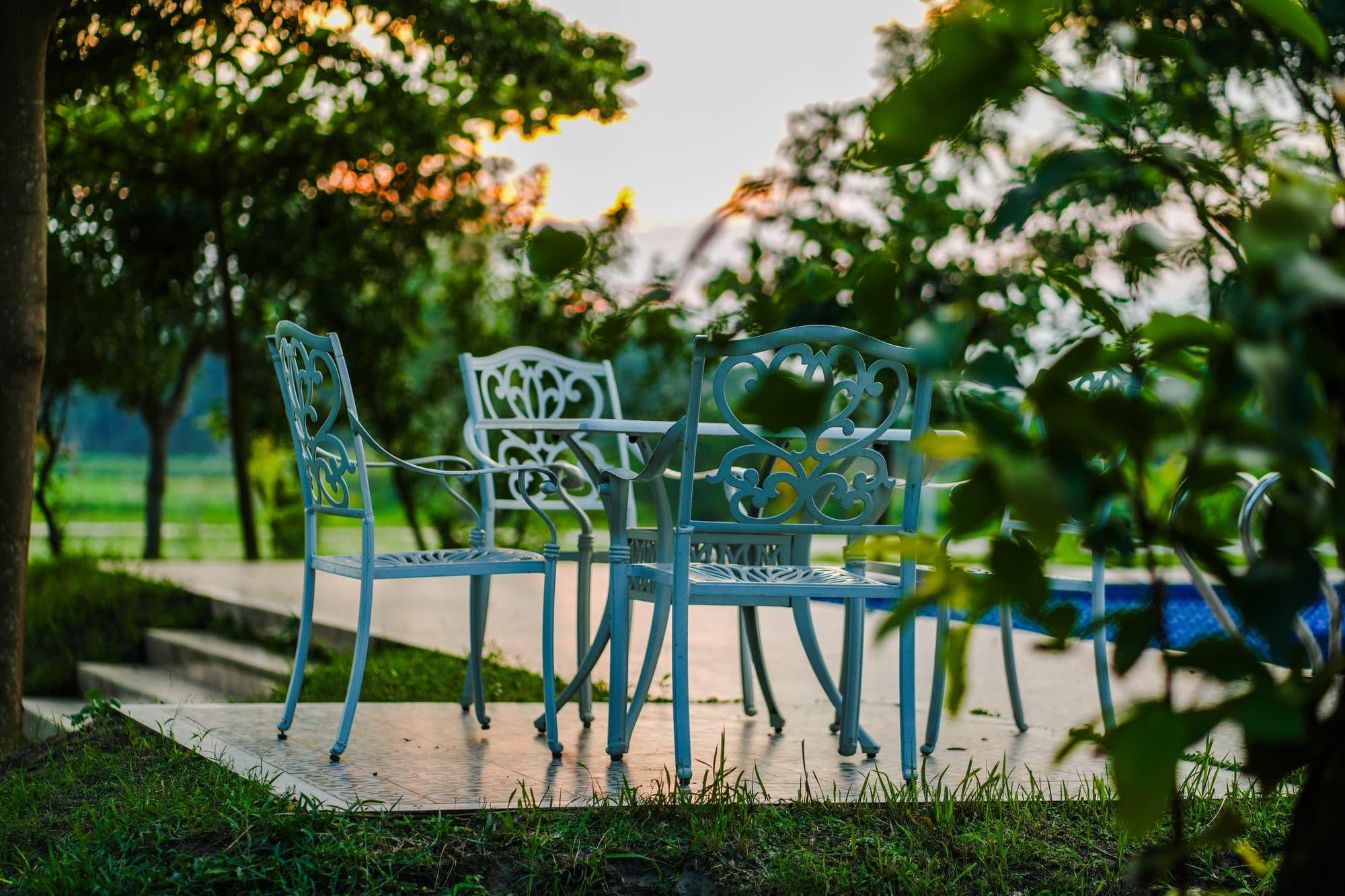 Garden chairs by the pool at dusk